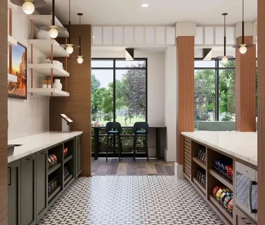 a kitchen with stainless steel appliances granite countertop a table chairs and a refrigerator