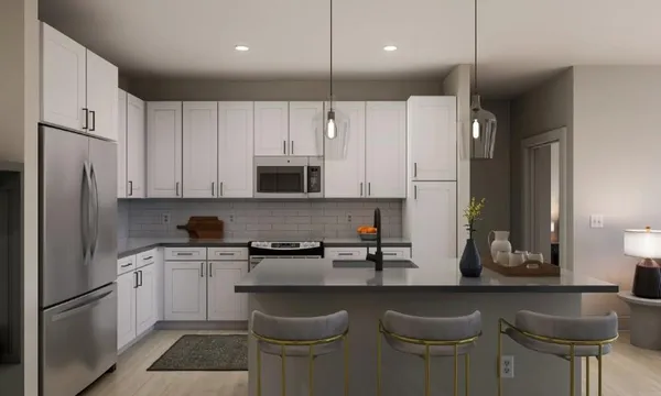 a kitchen with stainless steel appliances a sink a stove a refrigerator and cabinets