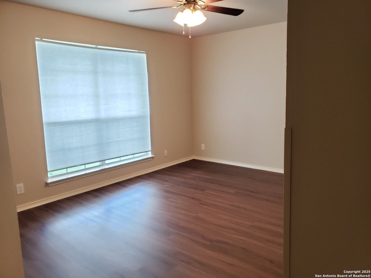 3659 Prairie Lane Schertz, TX 78154 - Photo 11 of 14 an empty room with wooden floor fan and window