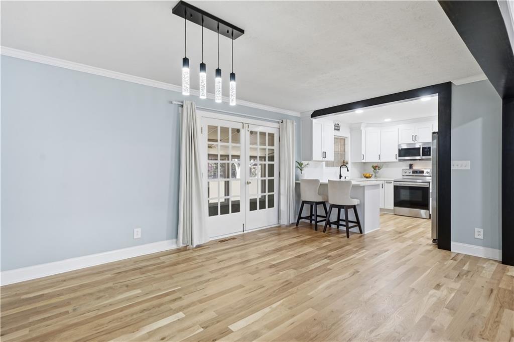 6413 Maddox Road Morrow, GA 30260 - Photo 14 of 43 a view of a dining room with furniture window and wooden floor