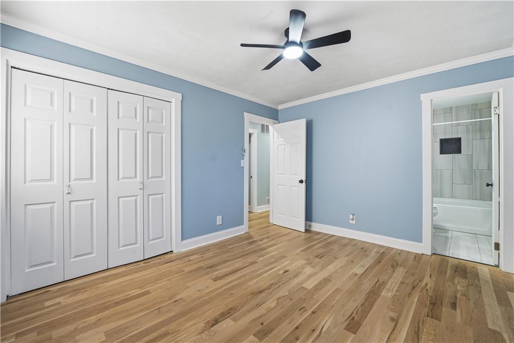 6413 Maddox Road Morrow, GA 30260 - Photo 29 of 43 a view of empty room with wooden floor and fan