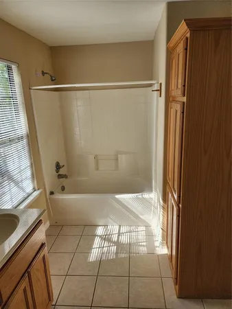en empty room with windows and fan