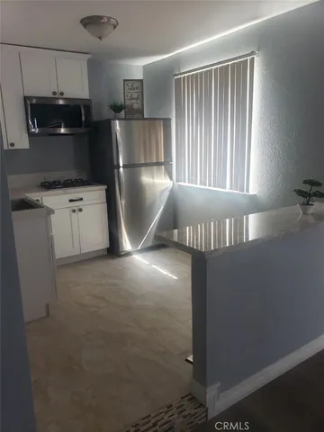 a kitchen with refrigerator and window