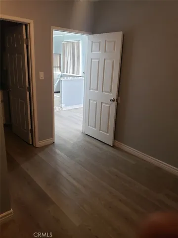 an empty room with wooden floor and a window