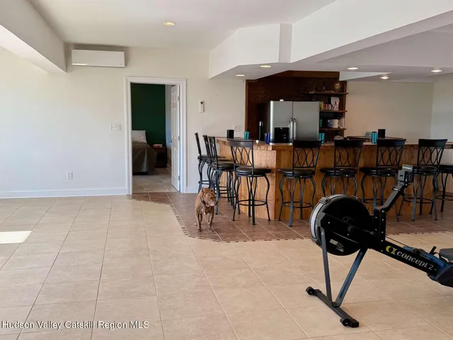 a dining room with furniture and a floor to ceiling window