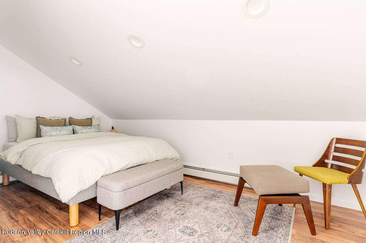 30 Aevo Road Accord, NY 12404 - Photo 23 of 41 a bedroom with a bed a chair and potted plant