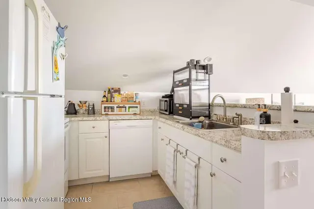 a kitchen with cabinets a sink and appliances