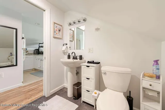a white toilet sitting next to a bathroom sink