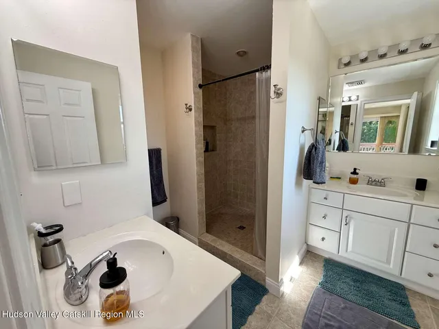 a bathroom with a tub sink and mirror