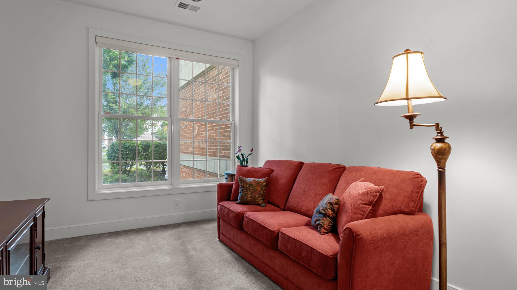 2102 Meridian Boulevard Warrington, PA 18976 - Photo 19 of 29 a blue couch sitting in a living room next to a window