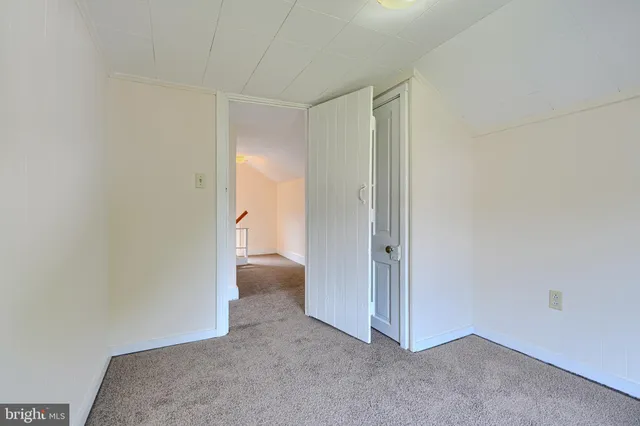 a view of an empty room and a bathroom