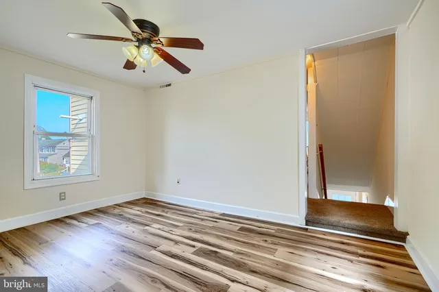 a view of room with window and wooden floor