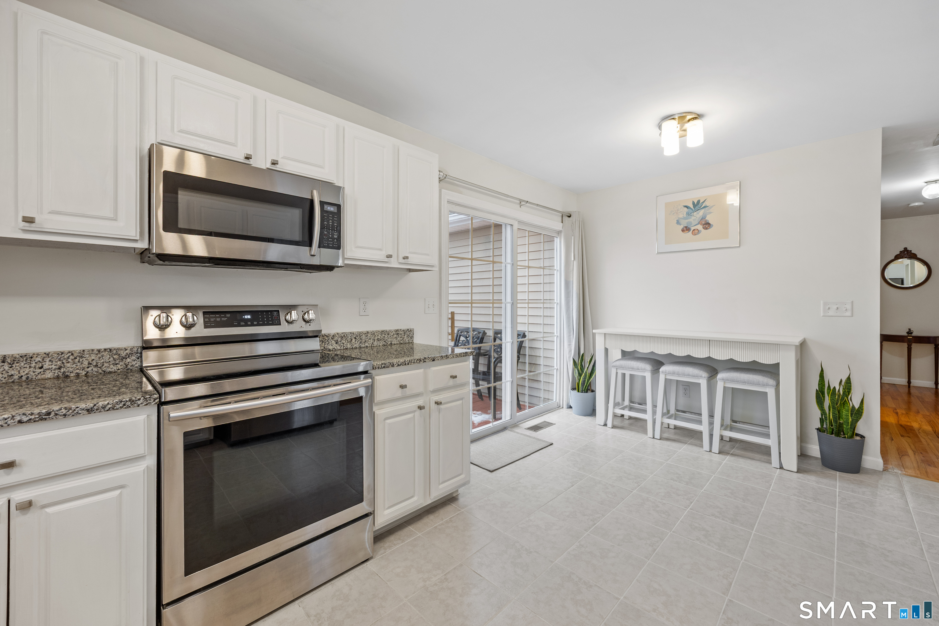 50 Paxton Street Watertown, CT 06779 - Photo 5 of 38 a kitchen with stainless steel appliances granite countertop a stove and a microwave