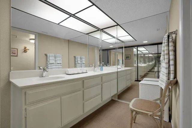 a bathroom with a sink a toilet and mirror