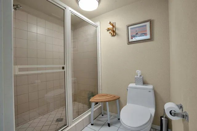 a white toilet sitting next to a bathroom sink