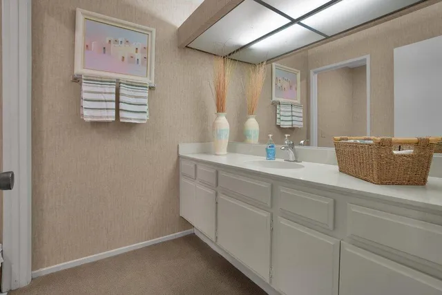 a bathroom with a sink and a mirror