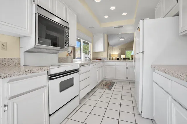 a kitchen with a stove a sink and a refrigerator