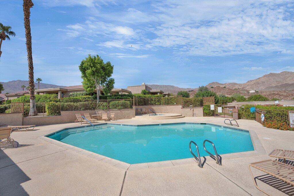 72302 Blueridge Court Palm Desert, CA 92260 - Photo 30 of 49 a view of a swimming pool and a terrace