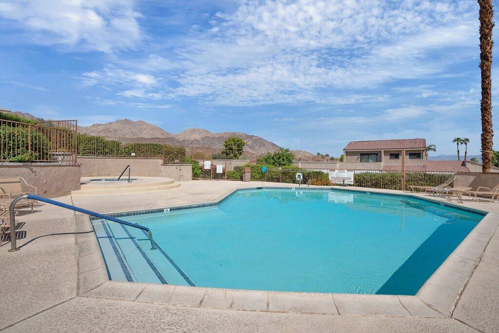 72302 Blueridge Court Palm Desert, CA 92260 - Photo 31 of 49 a view of a swimming pool with a terrace