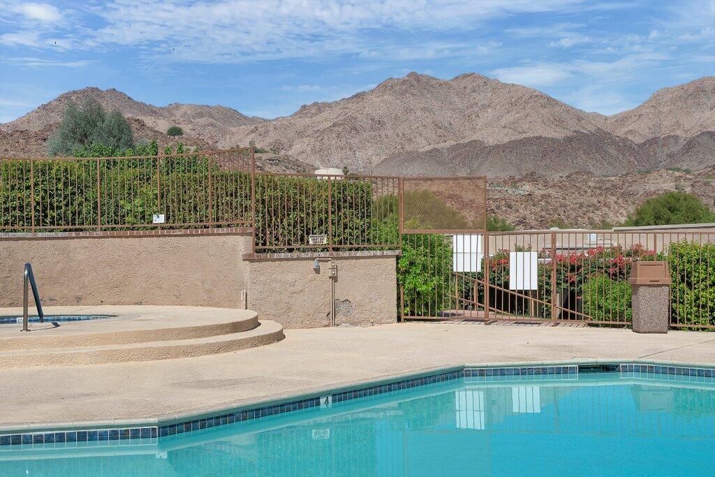 72302 Blueridge Court Palm Desert, CA 92260 - Photo 33 of 49 a view of a house with a yard and a wooden fence