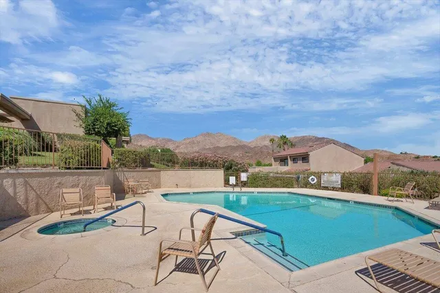 a view of swimming pool with a lounge chairs