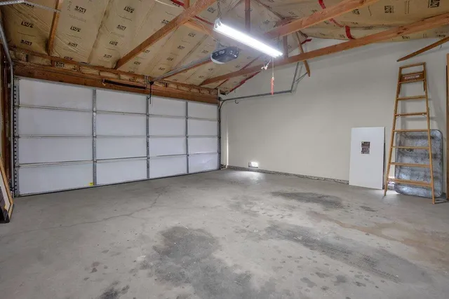 an aerial view of a house with a yard and lake view