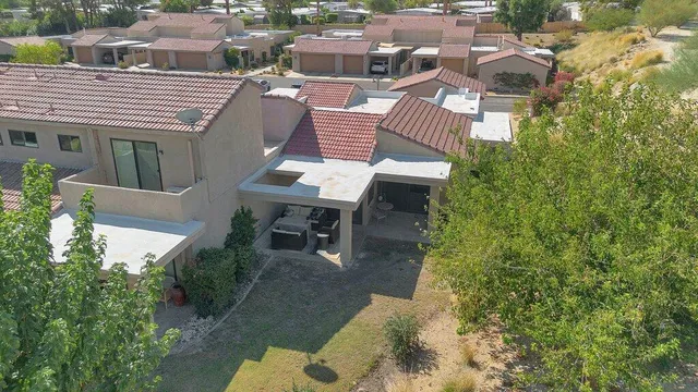 an aerial view of a house with a mountain