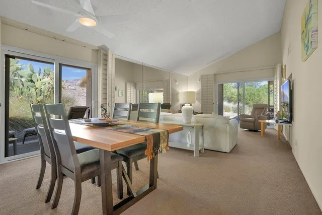 a view of a dining room with furniture and a large window