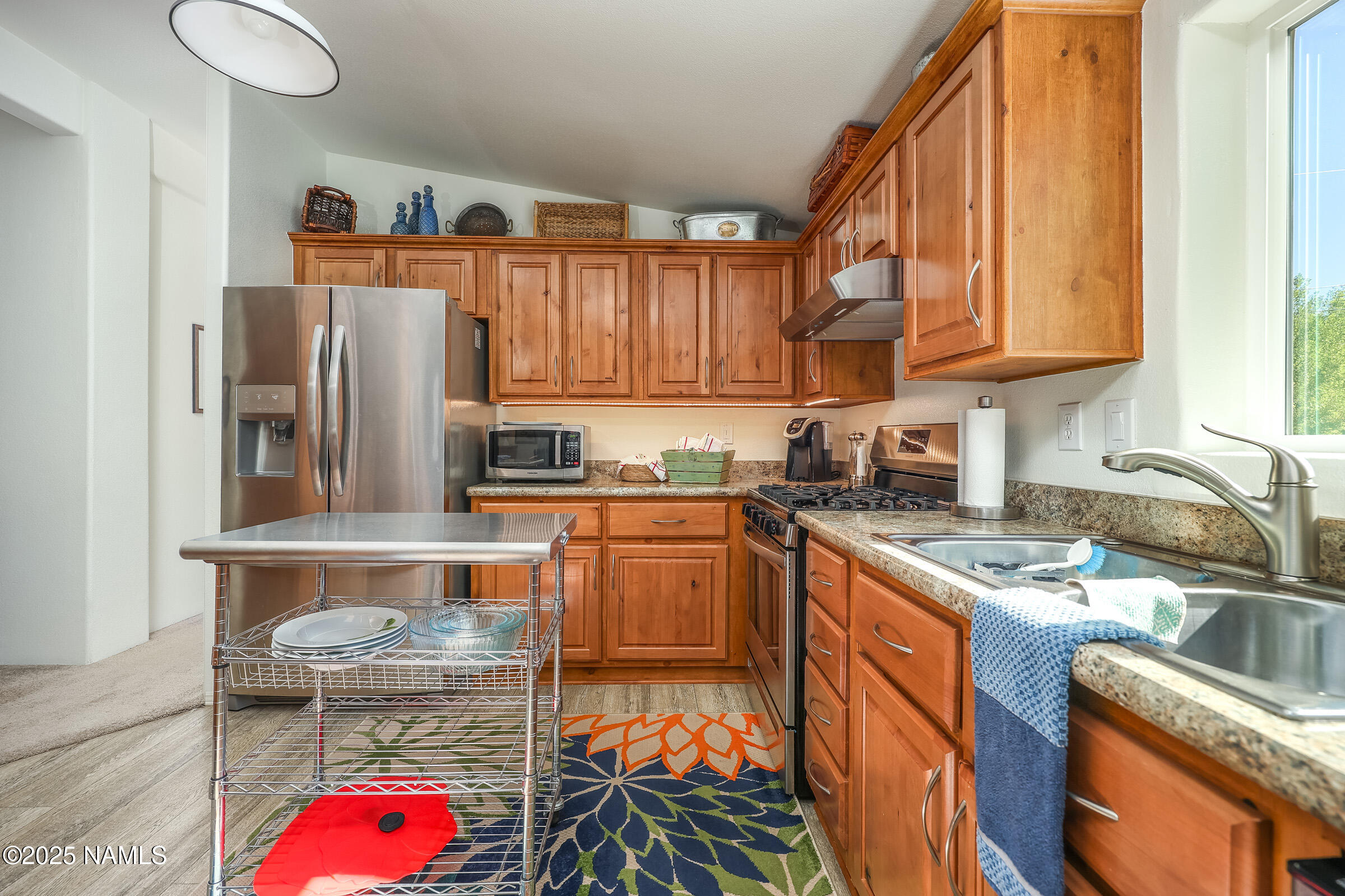 17265 Buffalo Run Munds Park, AZ 86017 - Photo 12 of 51 a kitchen with stainless steel appliances granite countertop a refrigerator sink and cabinets