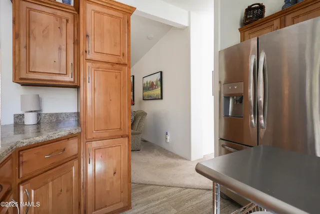 a kitchen with stainless steel appliances granite countertop a refrigerator and a cabinets