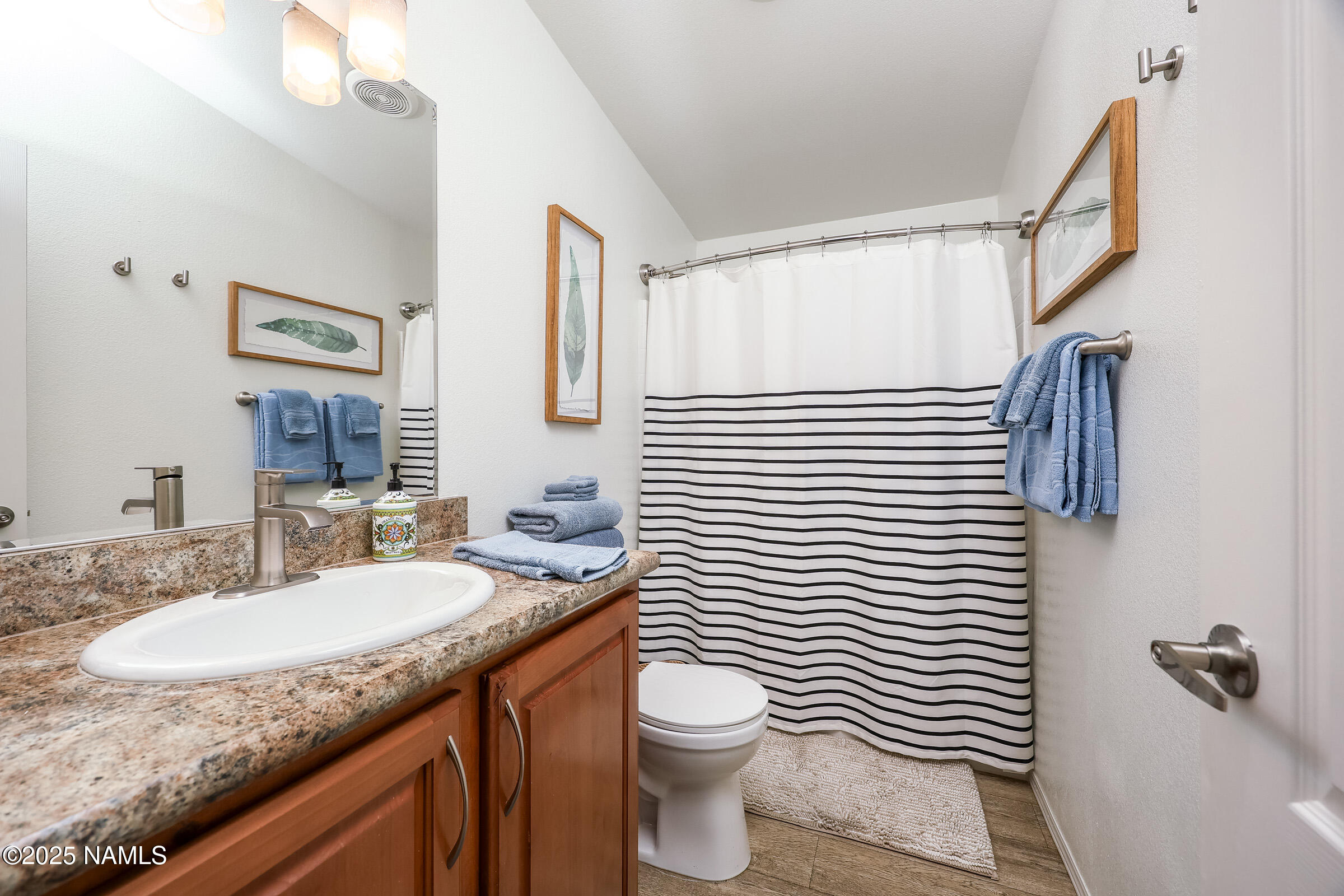 17265 Buffalo Run Munds Park, AZ 86017 - Photo 16 of 51 a bathroom with a granite countertop sink toilet and shower