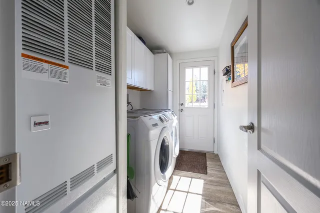 a view of a hallway with washer and dryer