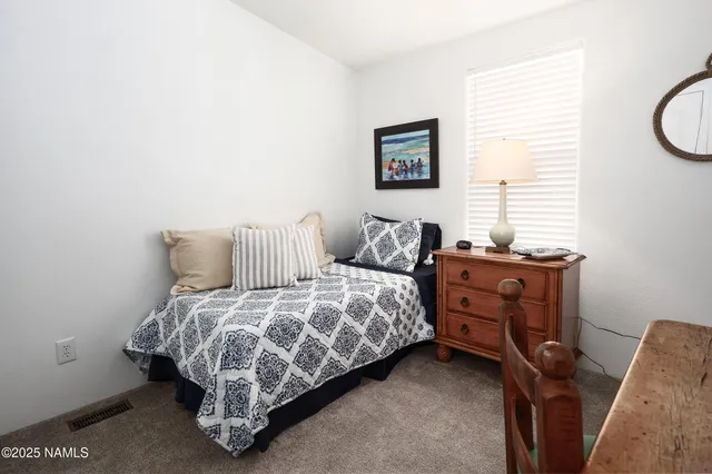 a bedroom with a bed and cabinets