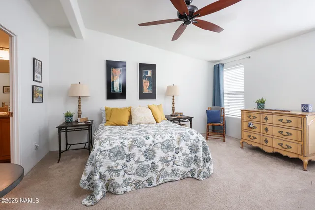 a bedroom with a bed and a chair in it