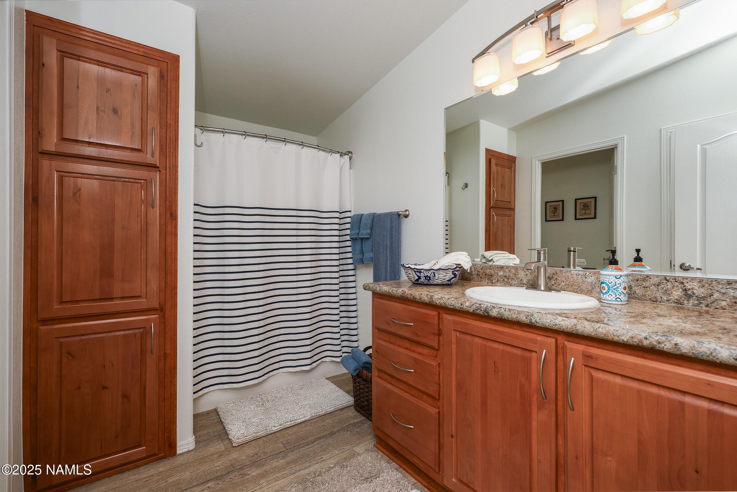 17265 Buffalo Run Munds Park, AZ 86017 - Photo 28 of 51 a bathroom with a granite countertop sink and a mirror