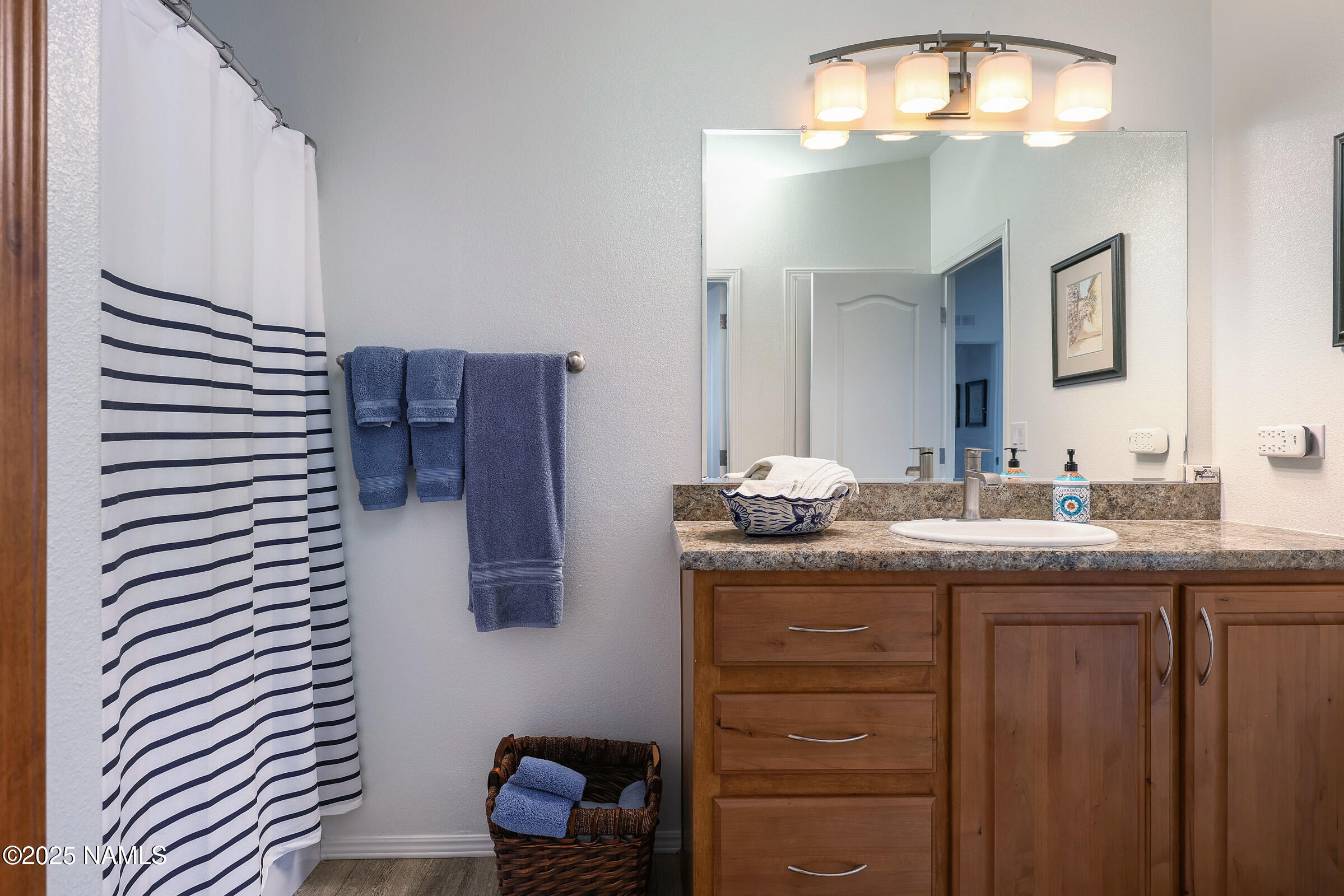 17265 Buffalo Run Munds Park, AZ 86017 - Photo 29 of 51 a bathroom with a granite countertop sink and a mirror