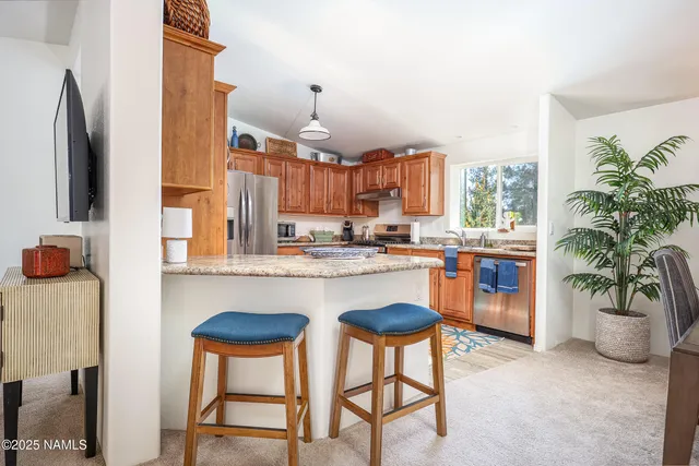 a kitchen with a table chairs and a refrigerator