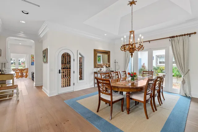 a bedroom with bed a flat tv screen and a large window with the garden view