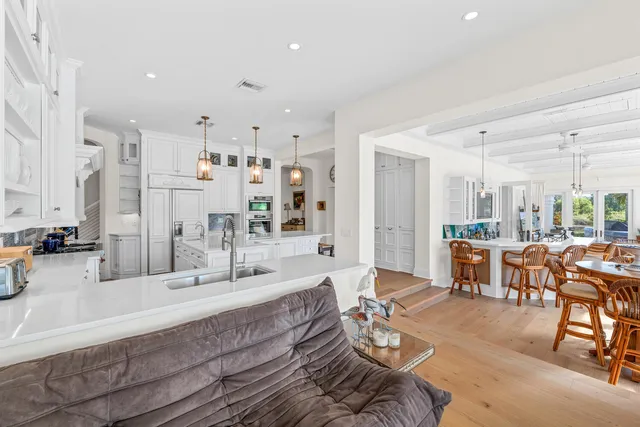 a bathroom with a granite countertop sink a large mirror a vanity and a shower