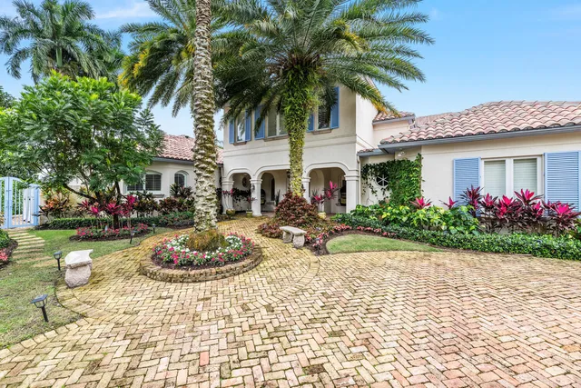 a swimming pool with outdoor seating and garden