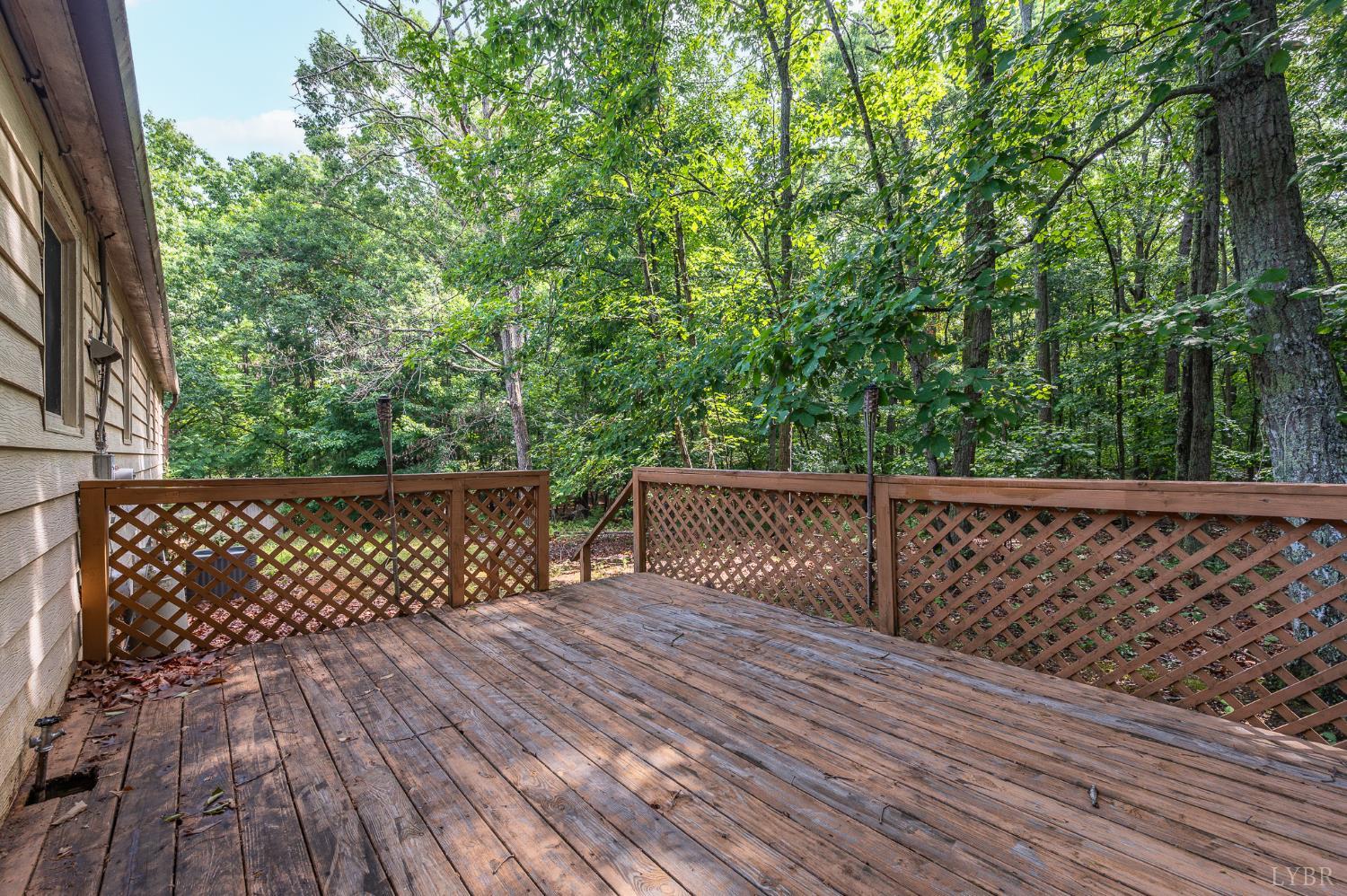 969 Hawkins Road Evington, VA 24550 - Photo 5 of 40 The 12x16 deck is on the back accessed from double slider glass doors at the end of the Sunporch; with stairs to the yard.