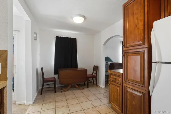 a view of kitchen with windows and refrigerator