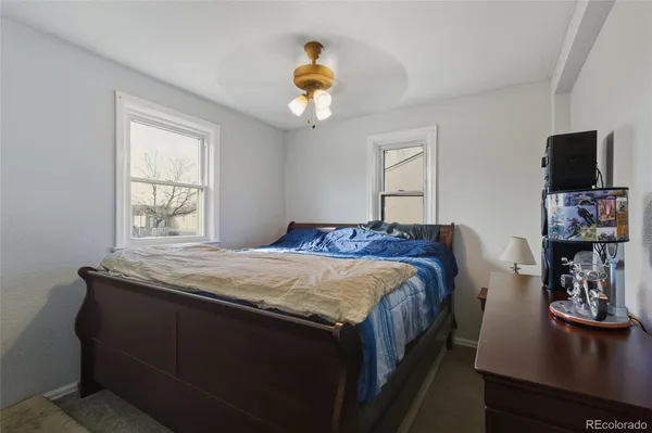 a bedroom with a large bed and a flat tv screen on a dresser