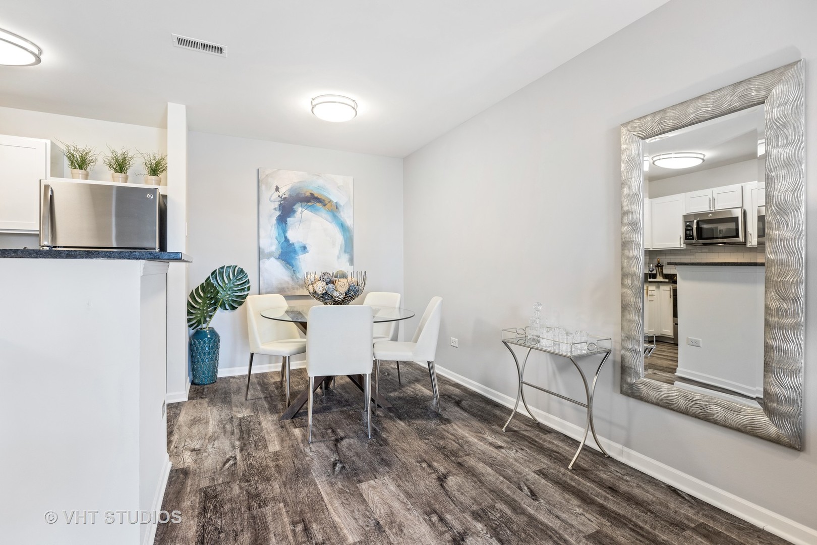 406 Mozart Court, Unit 406 Wheaton, IL 60189 - Photo 40 of 61 a view of a dining room with furniture and wooden floor