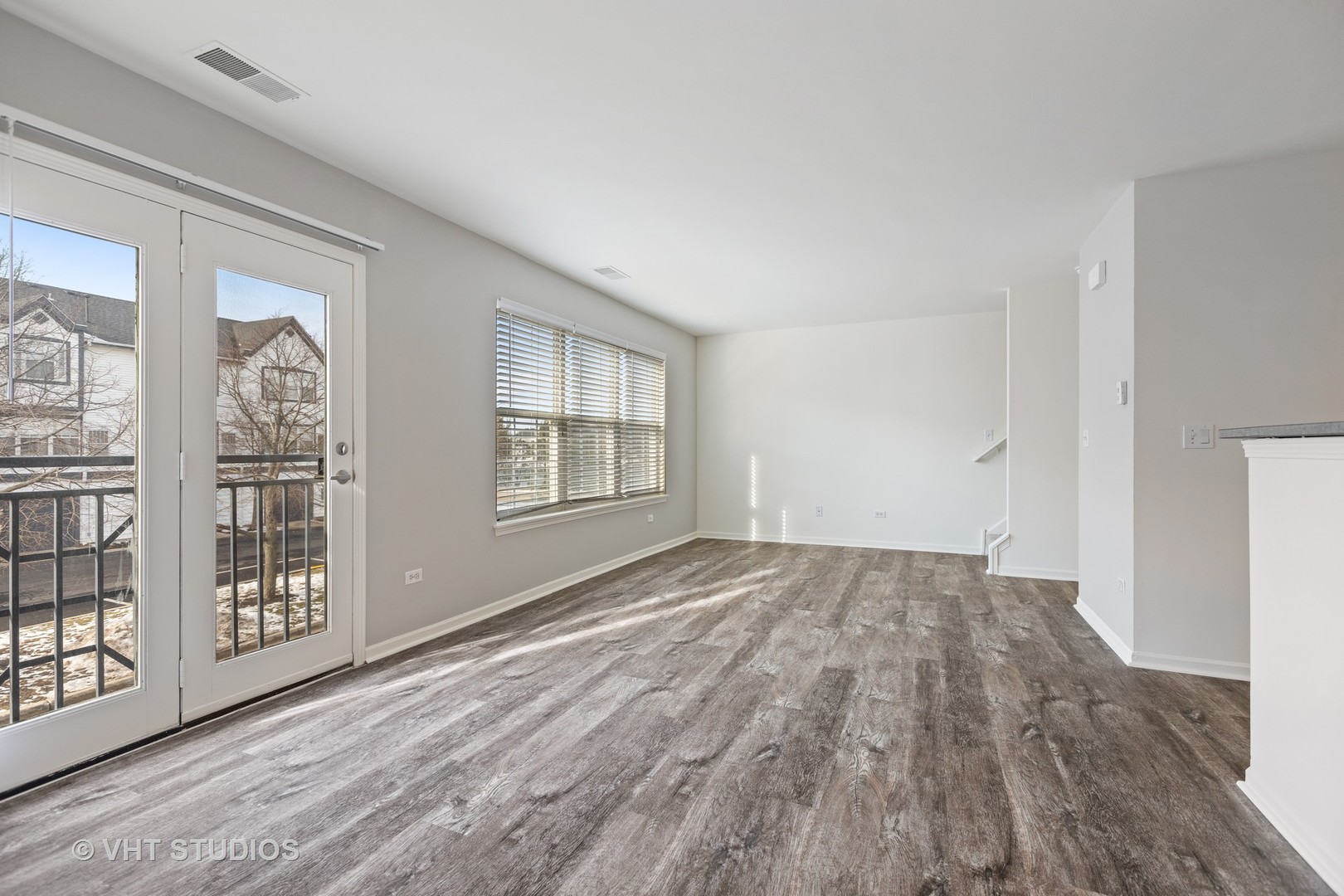 406 Mozart Court, Unit 406 Wheaton, IL 60189 - Photo 56 of 61 a view of an empty room with wooden floor and a window