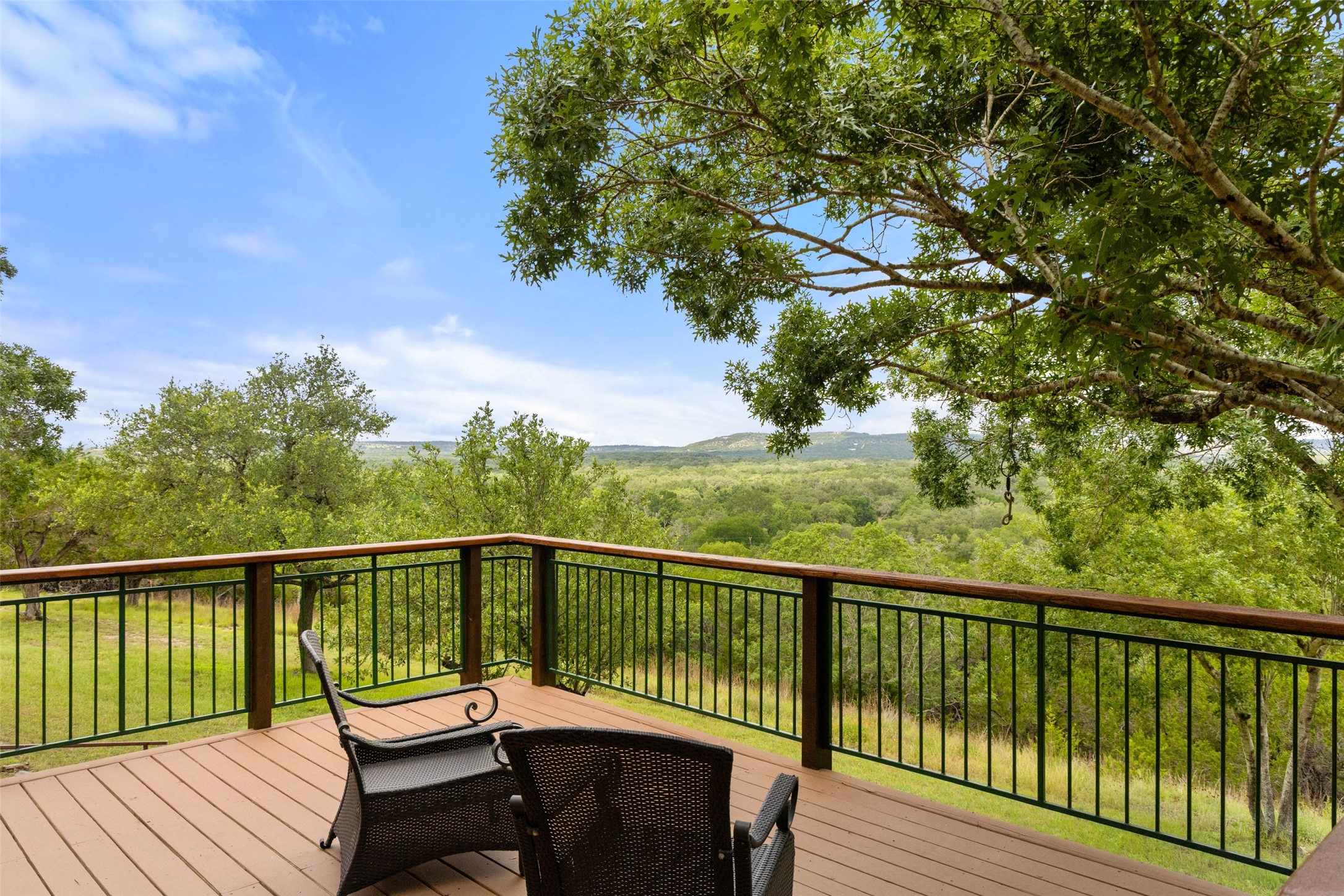 505 Red Corral Ranch Road Wimberley, TX 78676 - Photo 31 of 40 Enjoy scenic, long-range views from this elevated deck overlooking a verdant landscape.