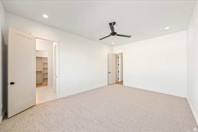 1491 East Centaurus Way, Unit 86 Washington, UT 84780 - Photo 14 of 26 Unfurnished bedroom with light carpet, a spacious closet, recessed lighting, and ceiling fan
