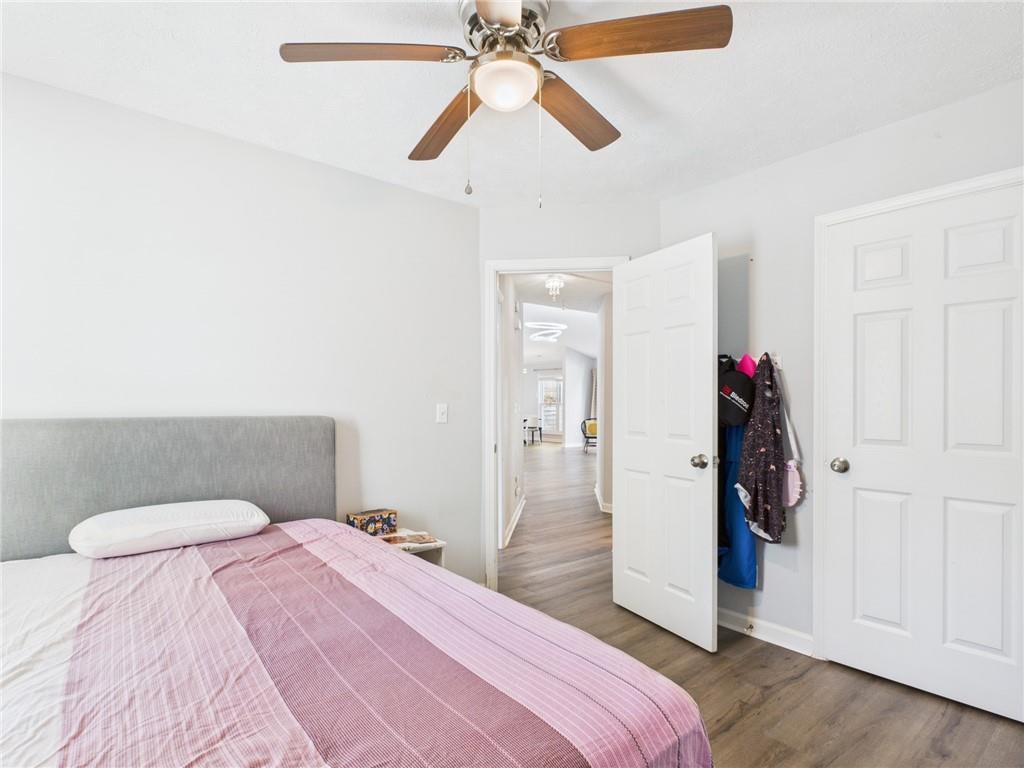 4060 Brooks Bridge Crossing Alpharetta, GA 30022 - Photo 17 of 30 a bedroom with a bed and a ceiling fan