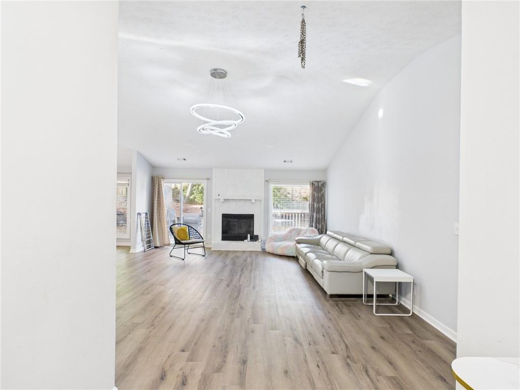 4060 Brooks Bridge Crossing Alpharetta, GA 30022 - Photo 2 of 30 a living room with furniture and a fireplace
