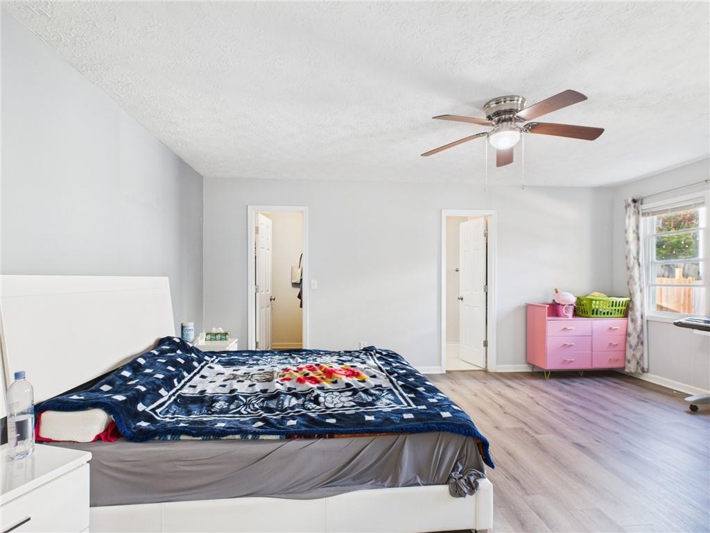 4060 Brooks Bridge Crossing Alpharetta, GA 30022 - Photo 22 of 30 a bedroom with a bed and a chandelier